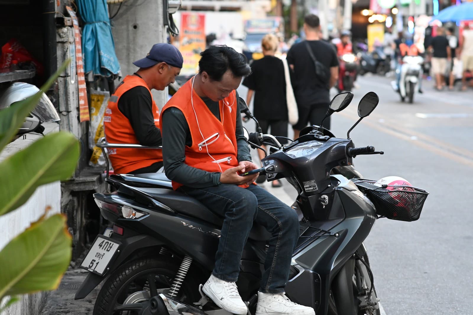 Tiziwiz SARL rider checking his phone before setting off on an express delivery run in Agadir